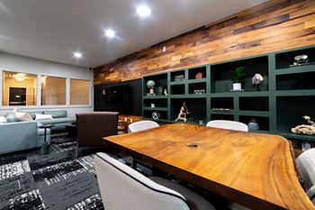 a conference room with a wooden table and green walls at 310 at Nulu Apartments-Student, Louisville, 40202